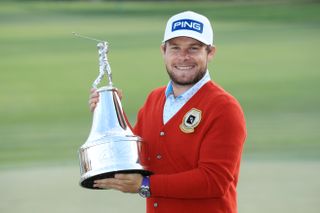 Tyrrell Hatton in the red sweater holding the trophy after winning the 2020 Arnold Palmer Invitational