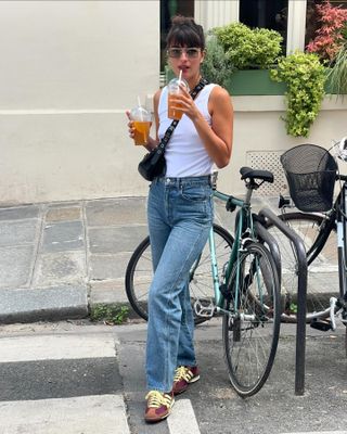 Woman in jeans and sneakers.