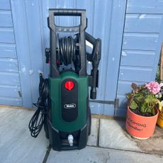 webb pressure washer in front of a blue shed