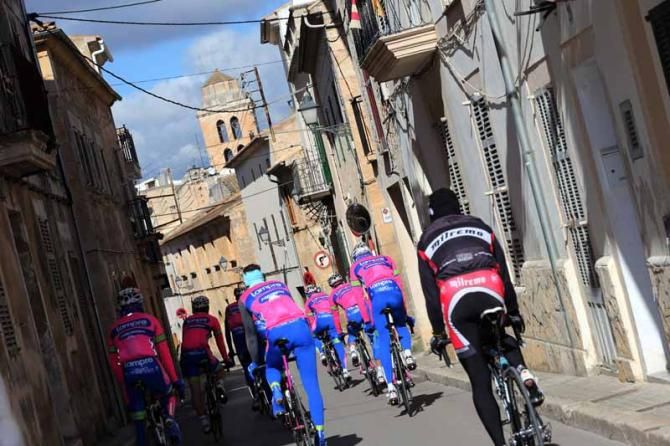 The team coast through a sleepy Mallorcan village