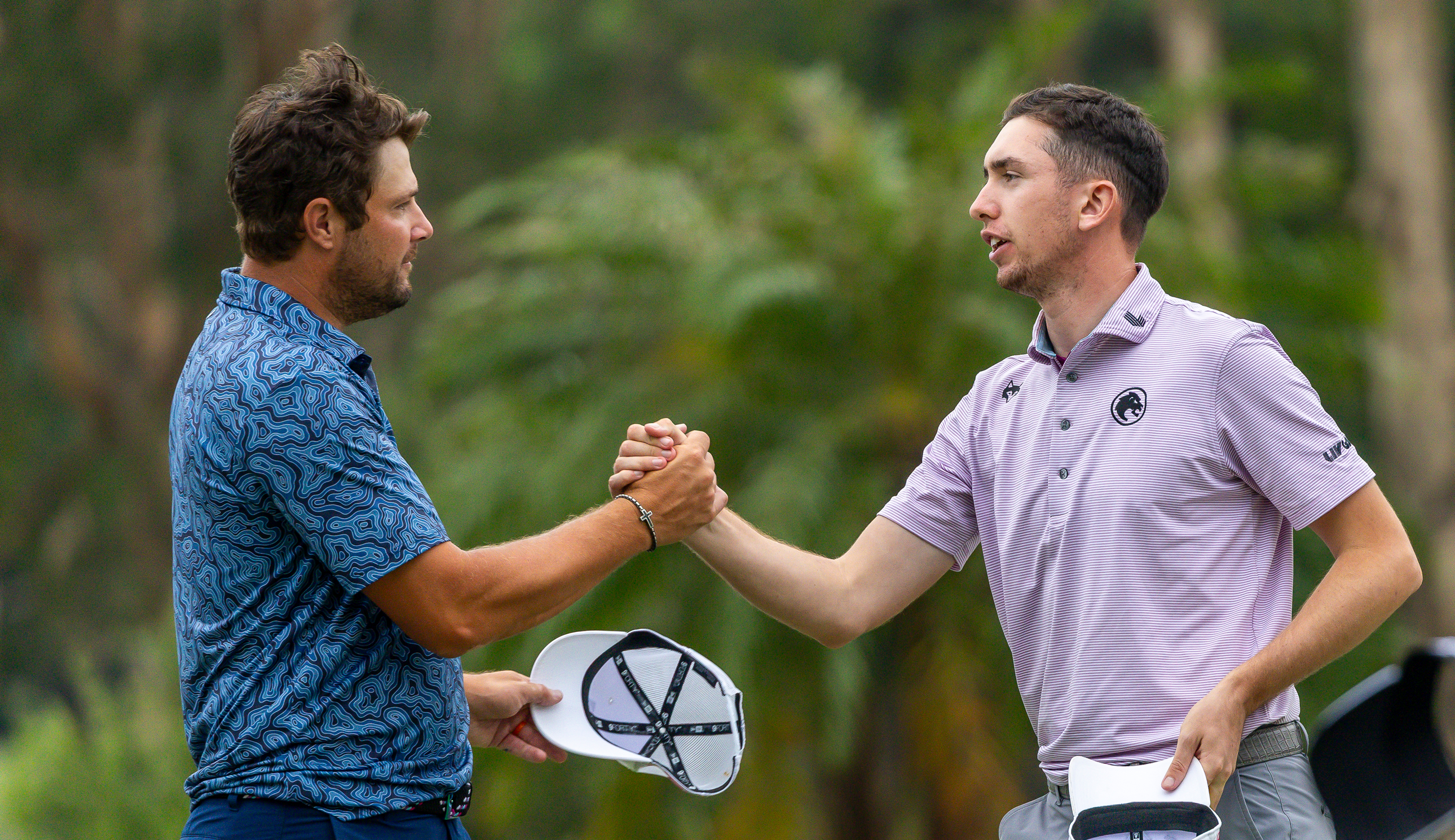 Peter Uihlein and Tom McKibbin shake hands