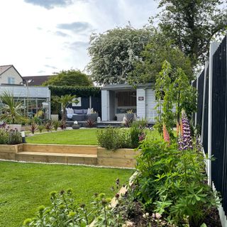 Garden with lawn, raised planters and shed