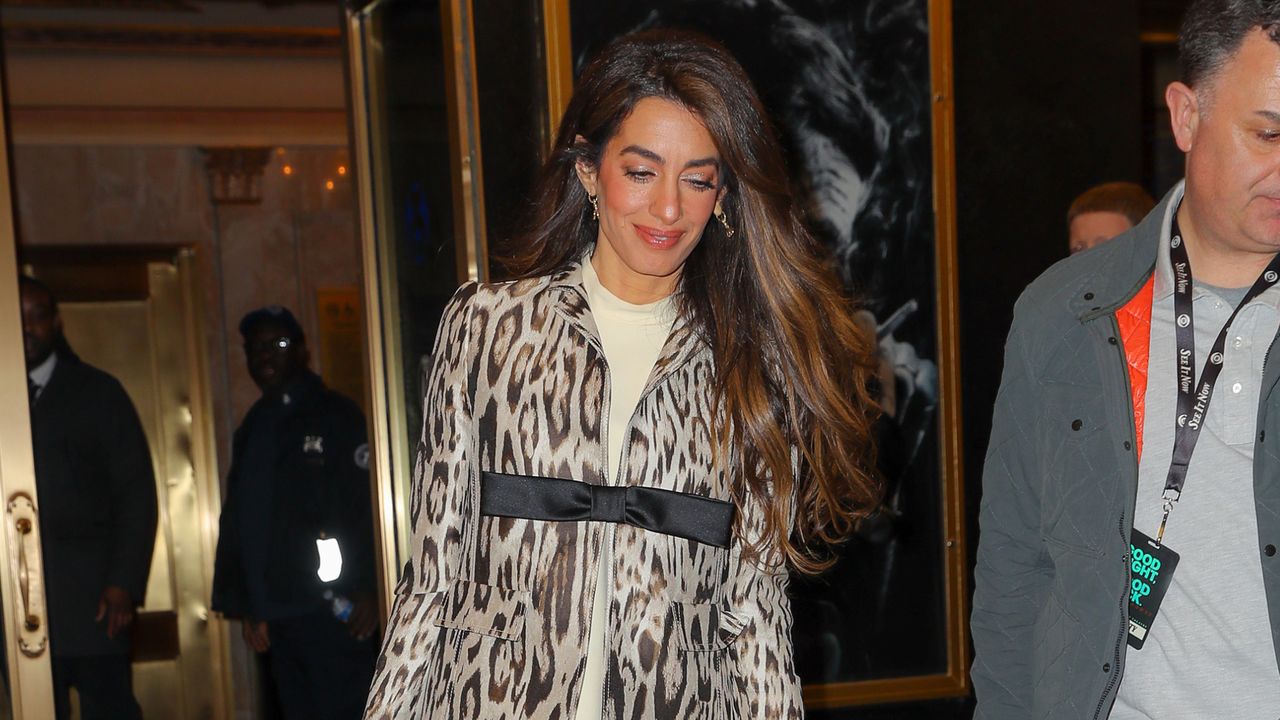 Amal Clooney leaving a broadway play in a leopard print coat and thigh high boots