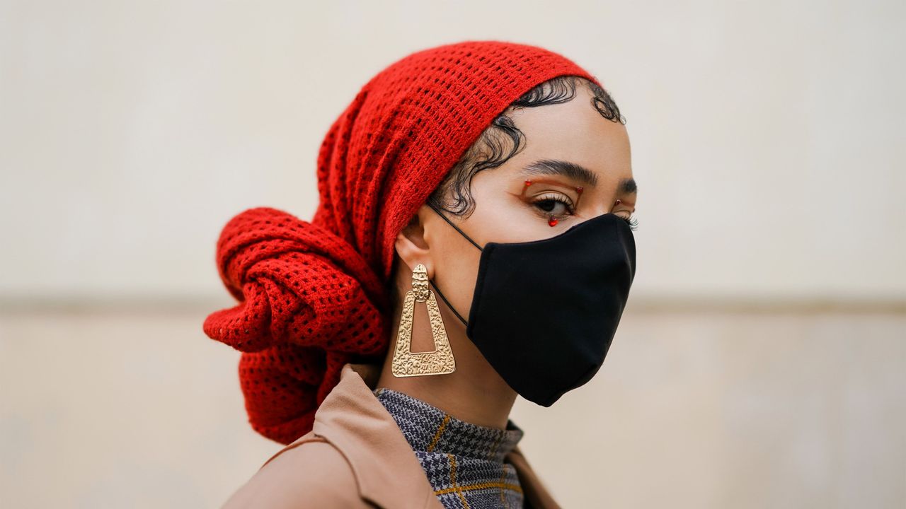 woman with red scarf and black face mask