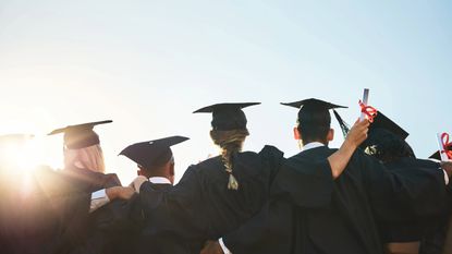 Rearview shot of a group of university students standing outside on graduation day