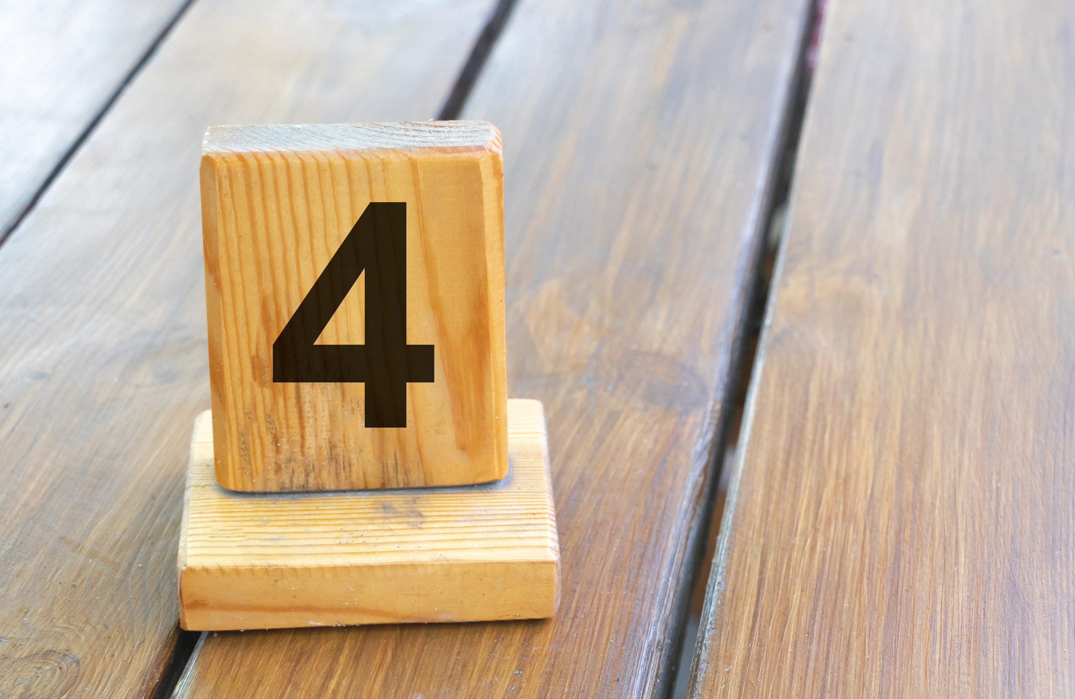 Wooden priority number 4 on a plank tab.