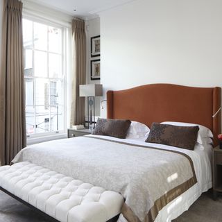 bedroom with white wall and windows