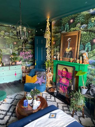 Dark jungle wallpaper in maximalist lounge with feature fireplace