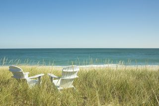 Adirondack chairs on sand dunes, Nantucket Island Massachusetts USA