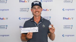 Jake Knapp holds up his scorecard and ball after shooting 59 (-12) at the 2025 Cognizant Classic