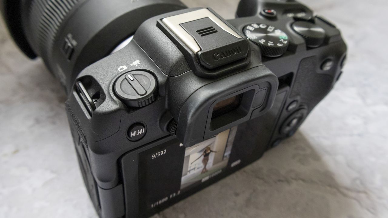 Canon EOS R8 camera on table and closeup of top plate with plain background