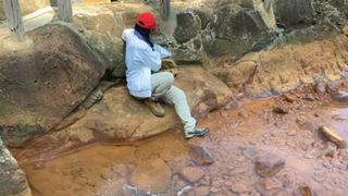 Researcher Fatima Li-Hau collects samples in a hot spring in Japan.