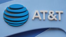 AT&T logo and branding pictured on a sign outside of an AT&T store in San Diego, California, USA.