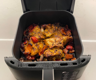 Ninja Air Fryer Pro 4-in-1 with charred roasted veg and chicken fillets in the basket