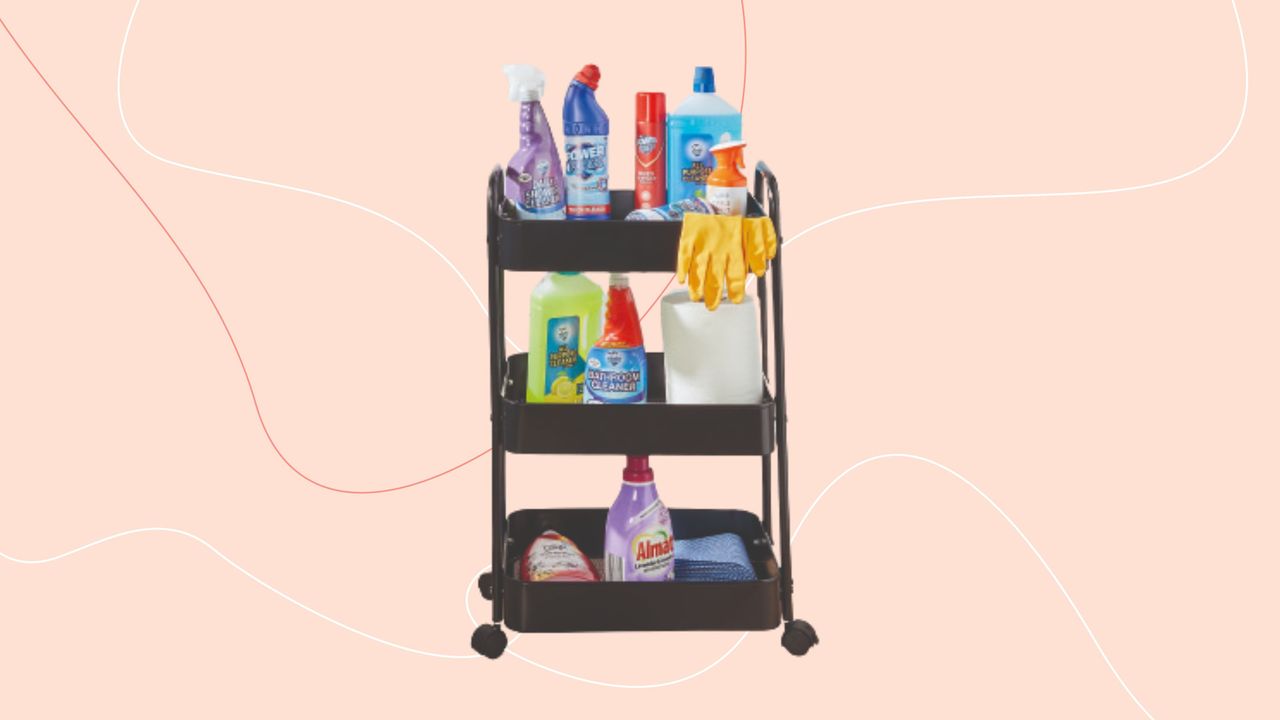 Black three tier storage trolley on pink background