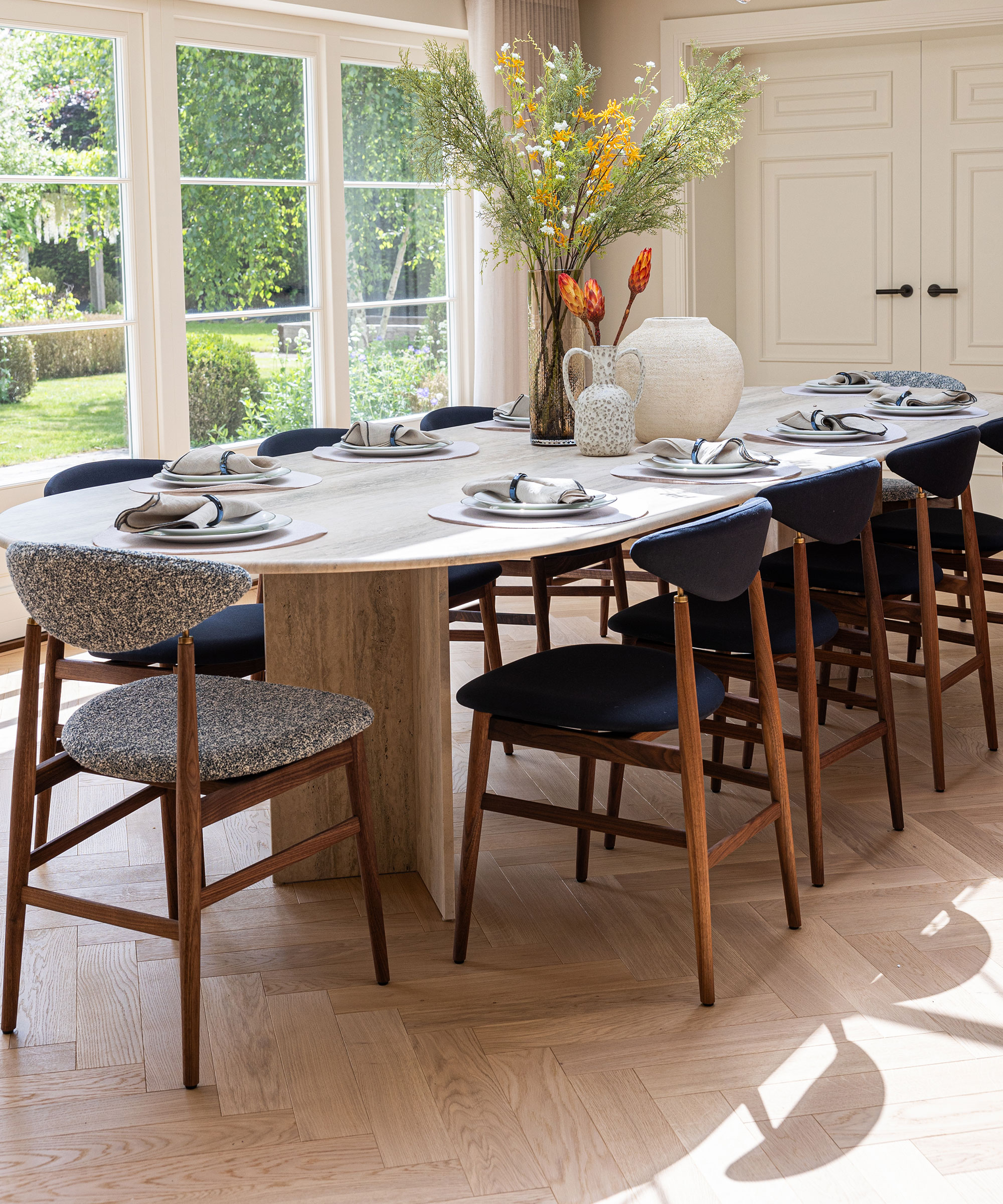 bright dining room with French doors and pale herringbone wood flooring