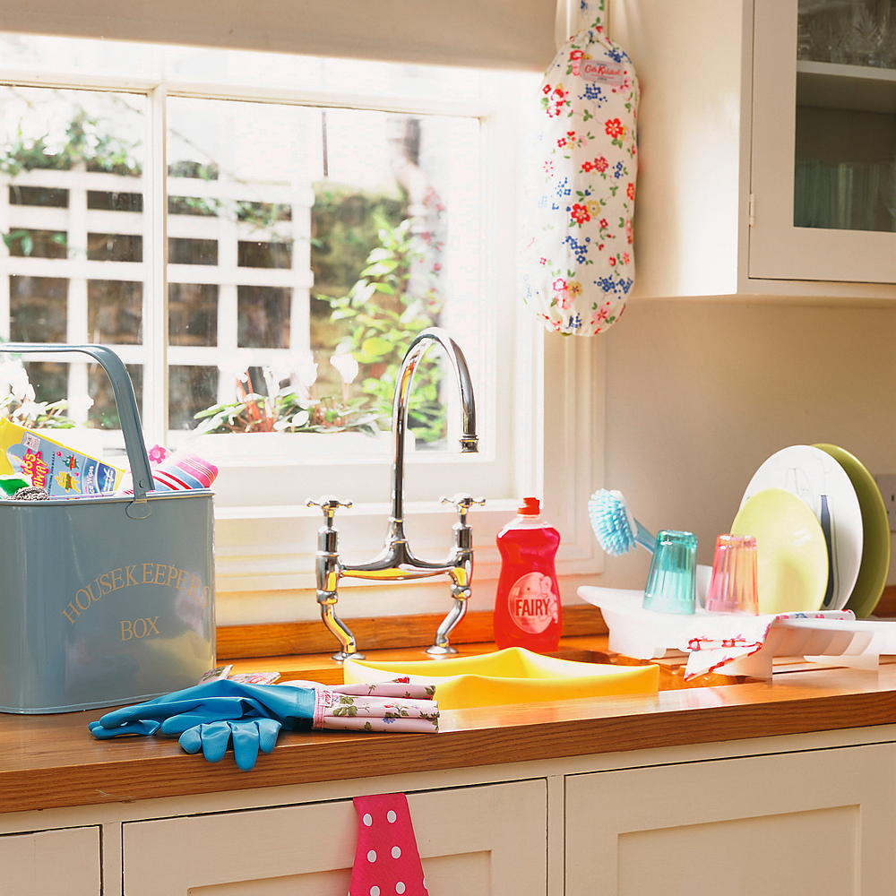 cleaning worktop with detergent liquid and bucket