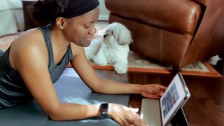Woman working on laptop with dog