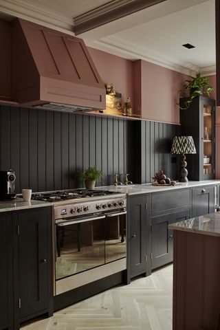 navy paneled walls with rust walls and range cooker