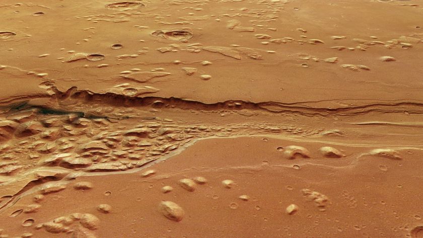a deep, ragged trench carved into a reddish-orange landscape