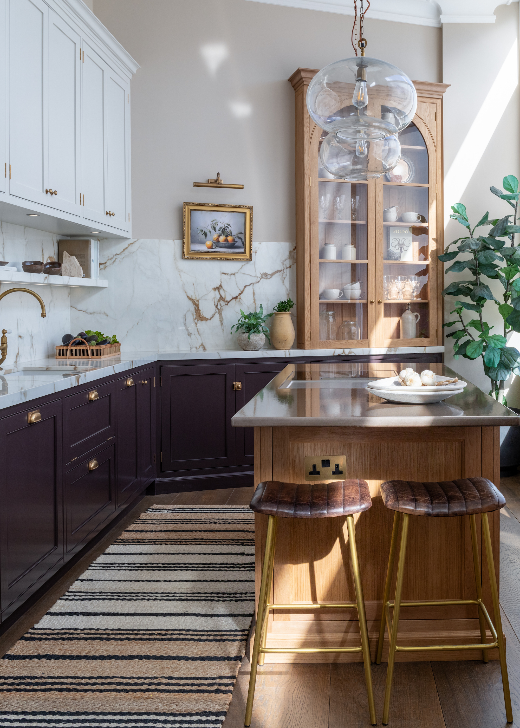 brown kitchen with oak island and white uppers