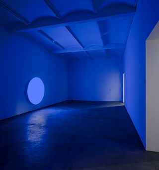 An empty room illuminated in blue