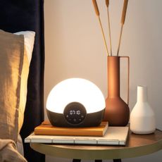 Best sunrise alarm clocks: A Lumie sunrise alarm clock on a bedside table