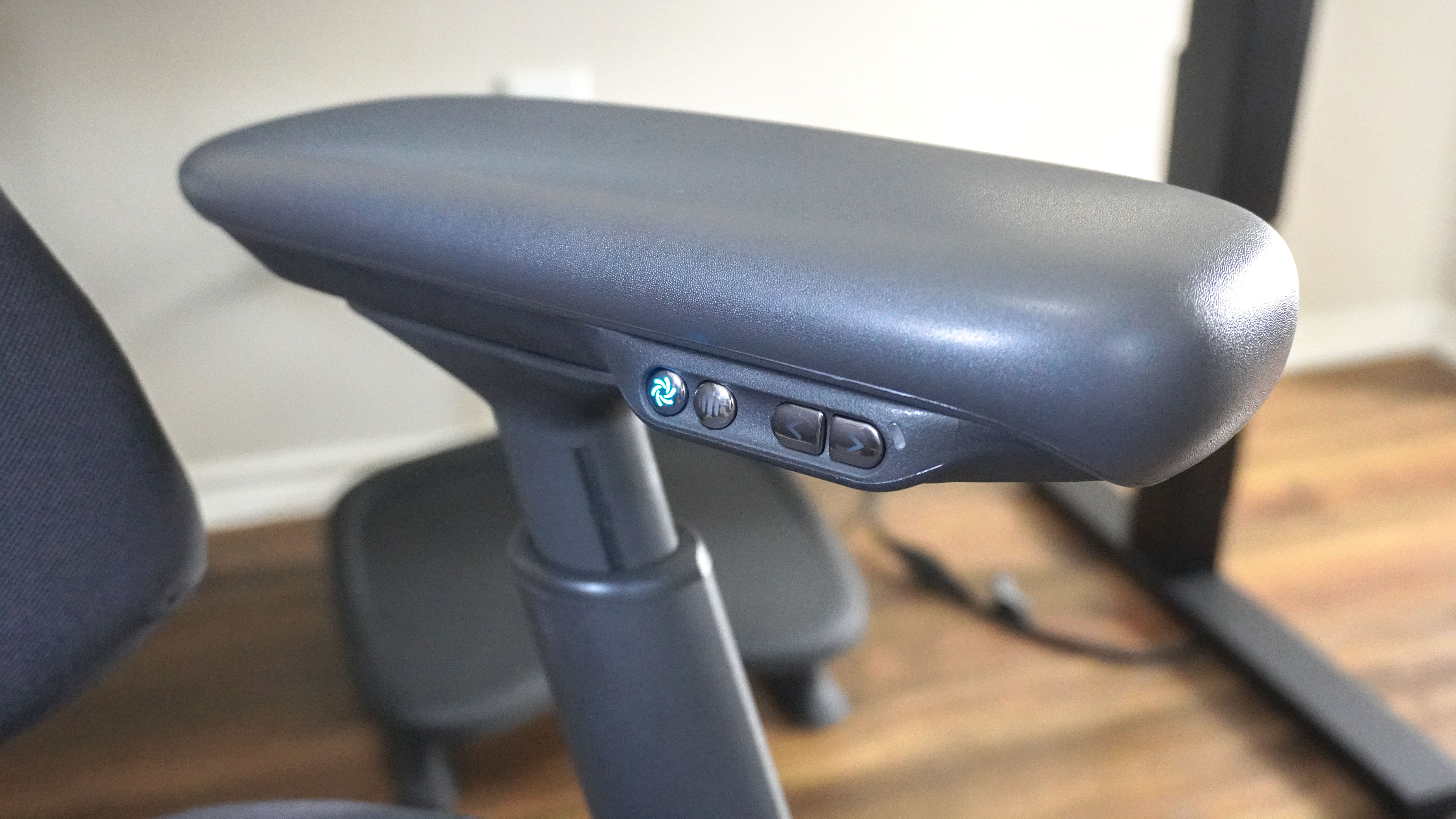 A close-up shot of the buttons on the left armrest of the LiberNovo Omni Pro