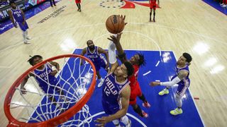 Tobias Harris #12 of the Philadelphia 76ers and OG Anunoby #3 of the Toronto Raptors reach for a rebound during Game One of the Eastern Conference First Round at Wells Fargo Center on April 16, 2022 in Philadelphia, Pennsylvania.