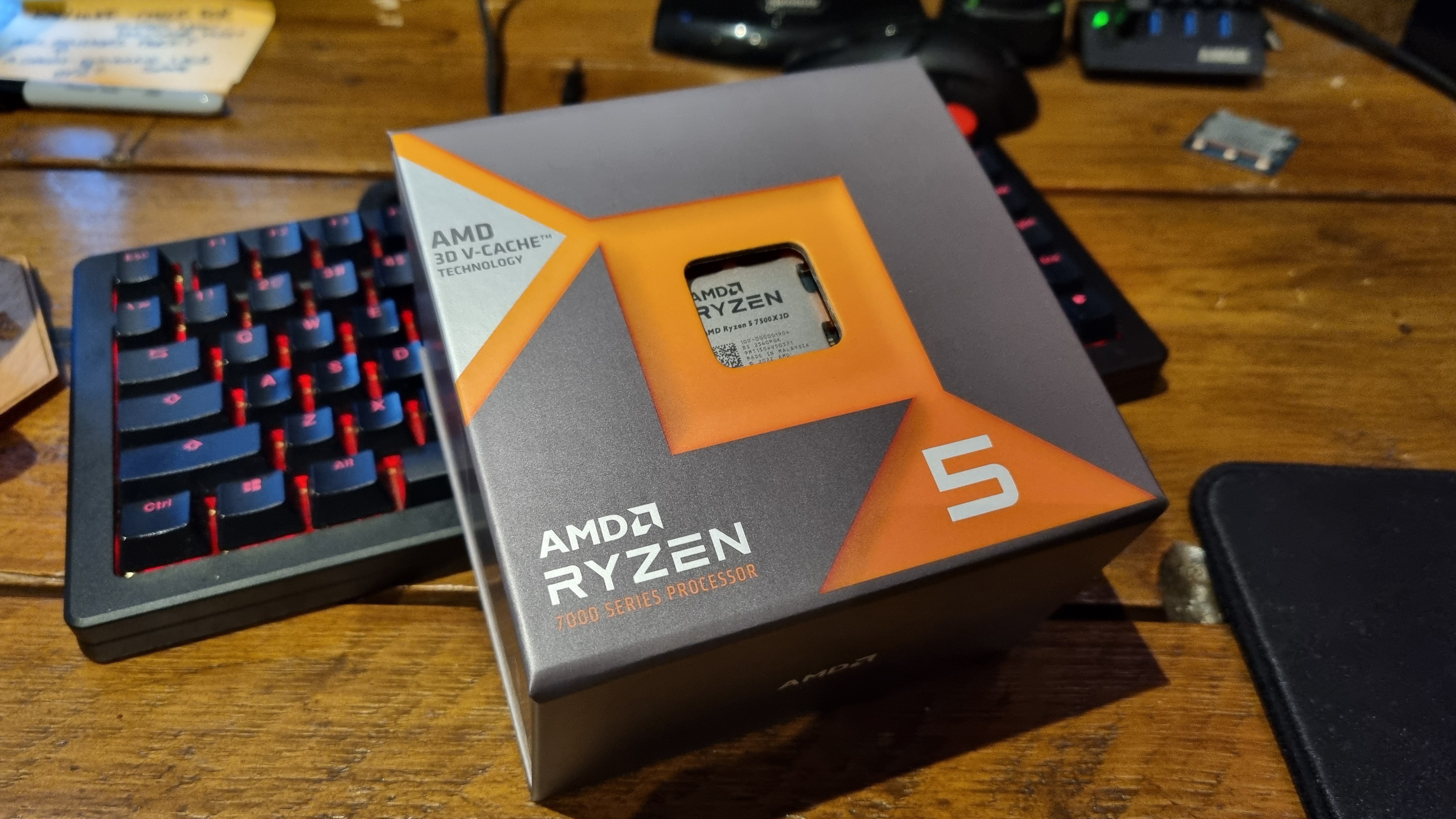 The AMD Ryzen 7500X3D in its box, resting against a gaming keyboard