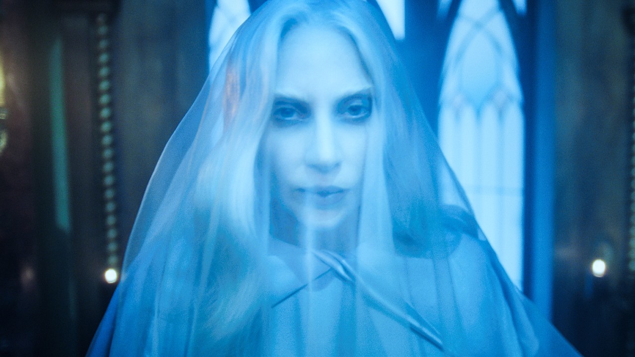 Lady Gaga wearing a white vail as Rosaline Rotwood in Wednesday Season 2.