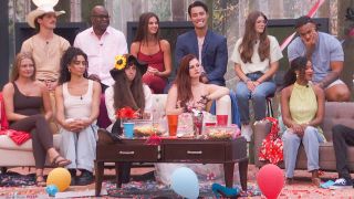 The Big Brother houseguests sitting outside
