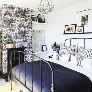 bedroom with plant and frames
