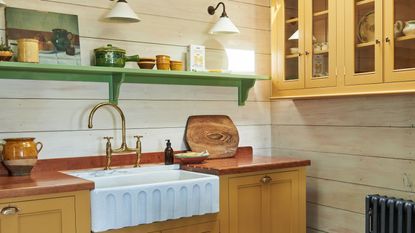 yellow kitchen cabinets with green shelf contrast