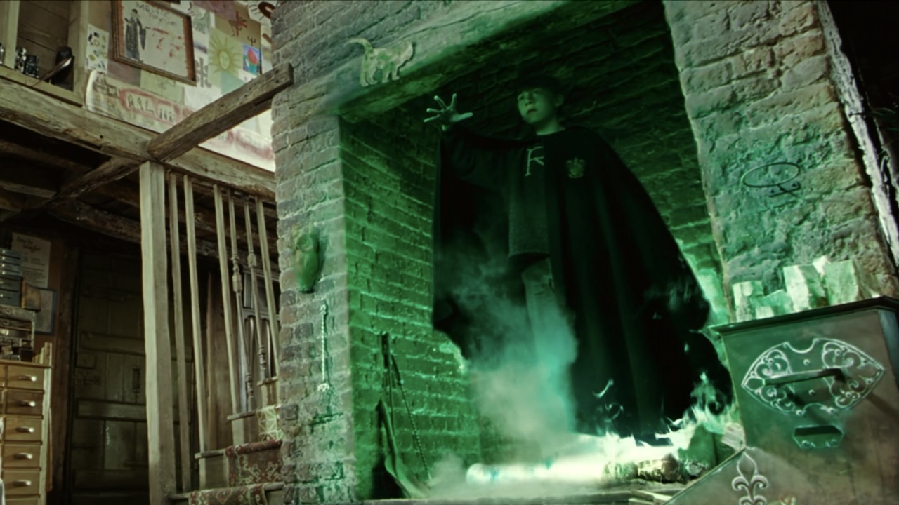 Ron using Floo powder in a fireplace in Harry Potter and the Chamber of Secrets