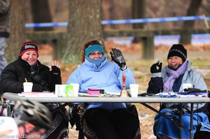 The race officials were bundled up due to the frigid weather.