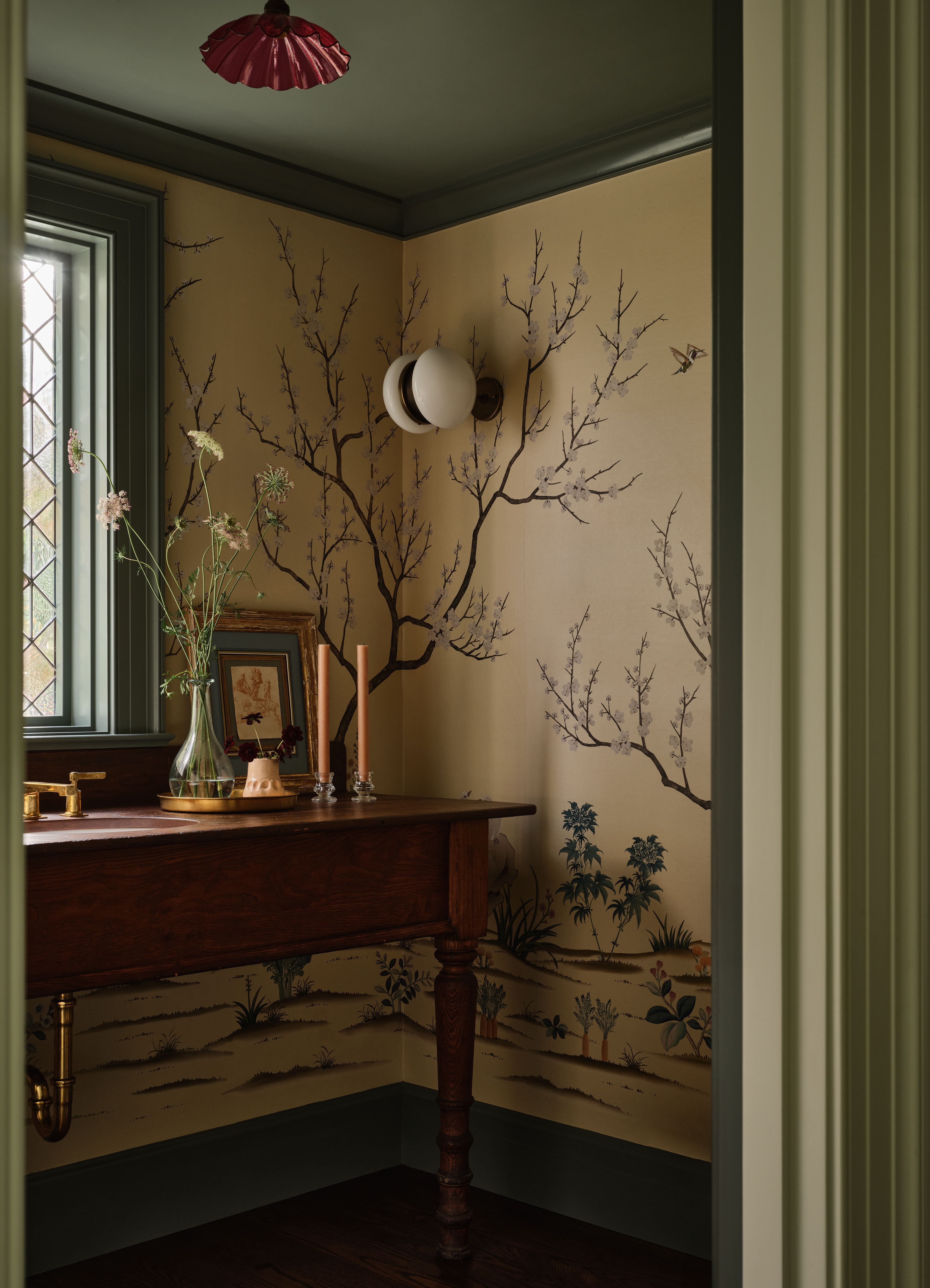 A corner of the home with a beige wallpaper, and dark green painted ceiling