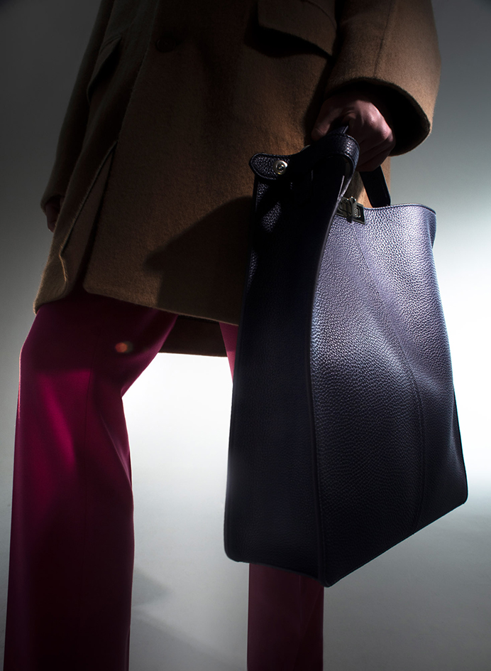 The model is holding bag
