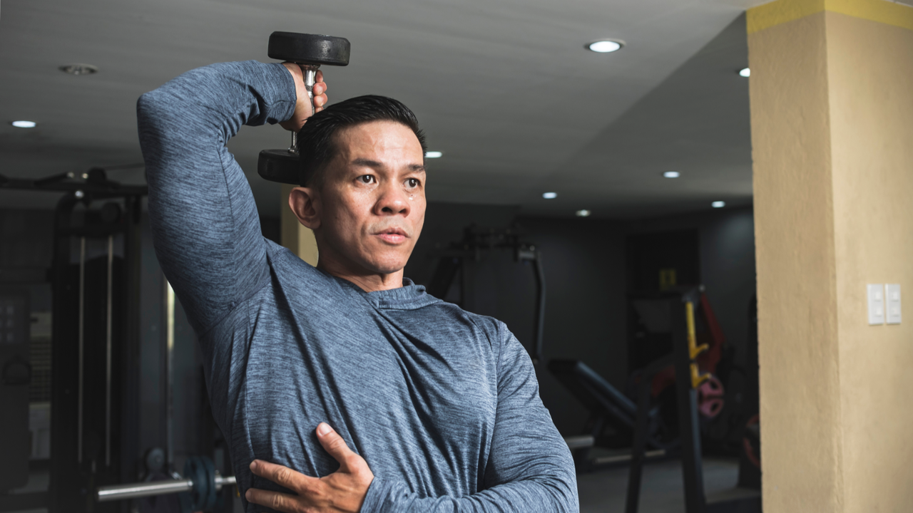 Man doing seated dumbbell exercises