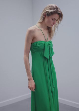 model wears green dress 