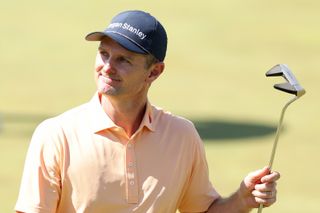 Justin Rose holds his putter up to the crowd