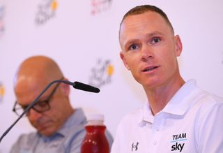 With Dave Brailsford in the background, Chris Froome talks with members of the media at Team Sky's pre-Tour press conference