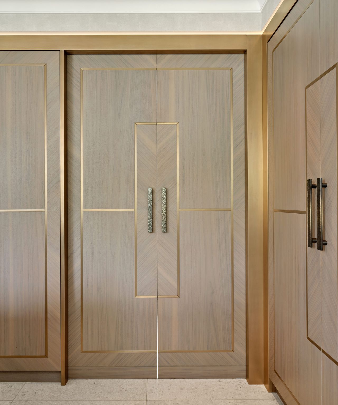 main kitchen with back kitchen area hidden by pocket sliding doors in cream with gold detailing