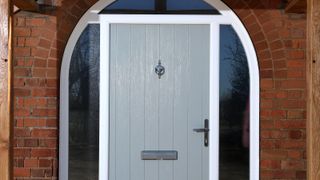 Composite front door with arched frame