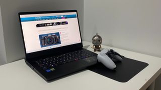 The MSI Vector GP66 with a Funko Pop and PS5 controller resting on a table