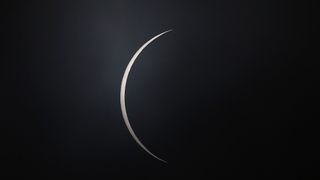 An atom of the sun appears after college as the moon moves across the sun during a total solar eclipse on December 14, 2020, in Teodoro Schmidt, Chile.