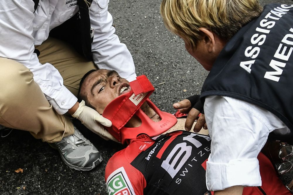 Richie Porte is attended by medical staff after crashing during stage 9 at the Tour de France