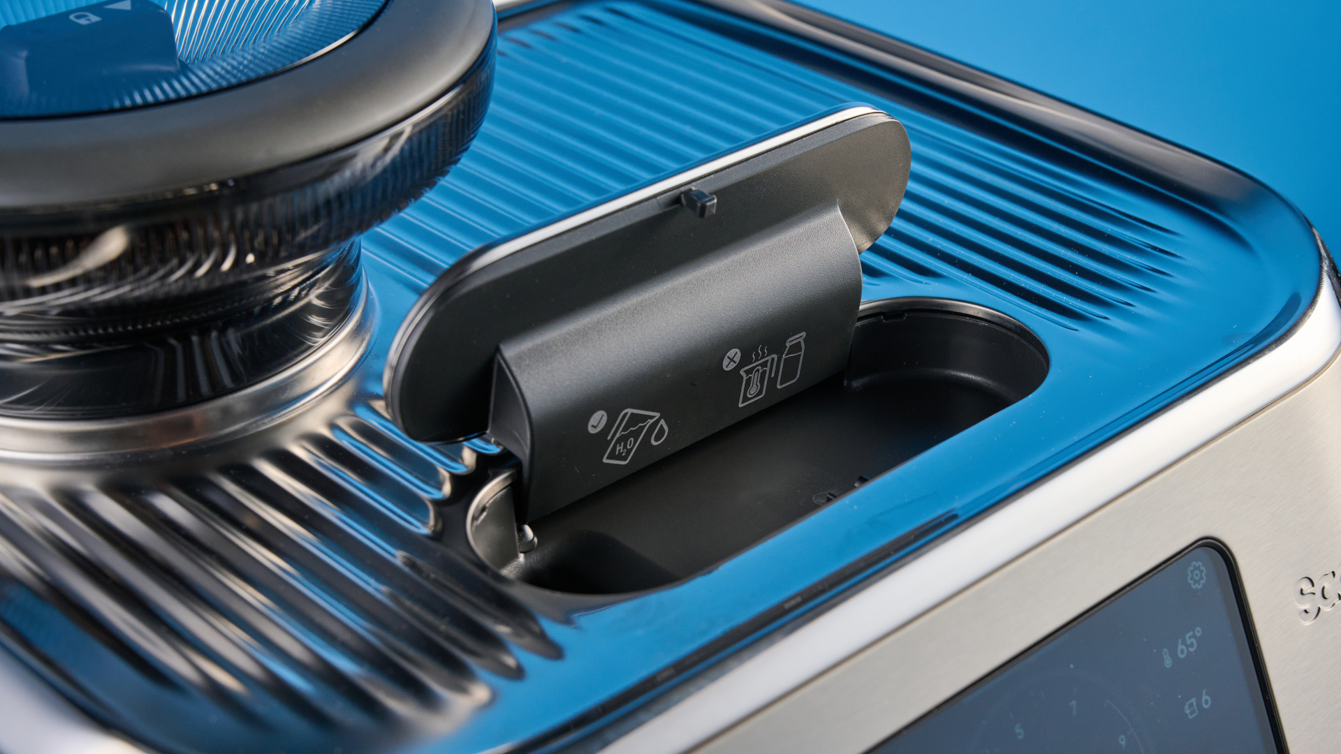 the breville oracle dual boiler / sage oracle dual boiler in stainless steel, showing its touchscreen, steam wand, built in grinder, and espresso shots