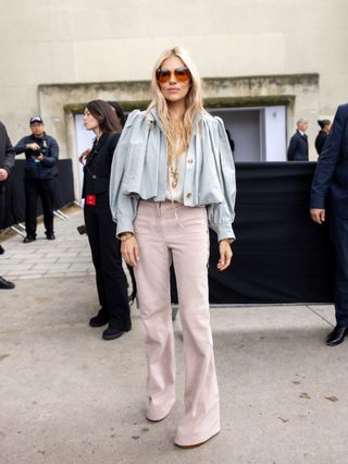 An image of Sienna Miller wearing a cropped jacket