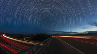 Star trails over a busy road